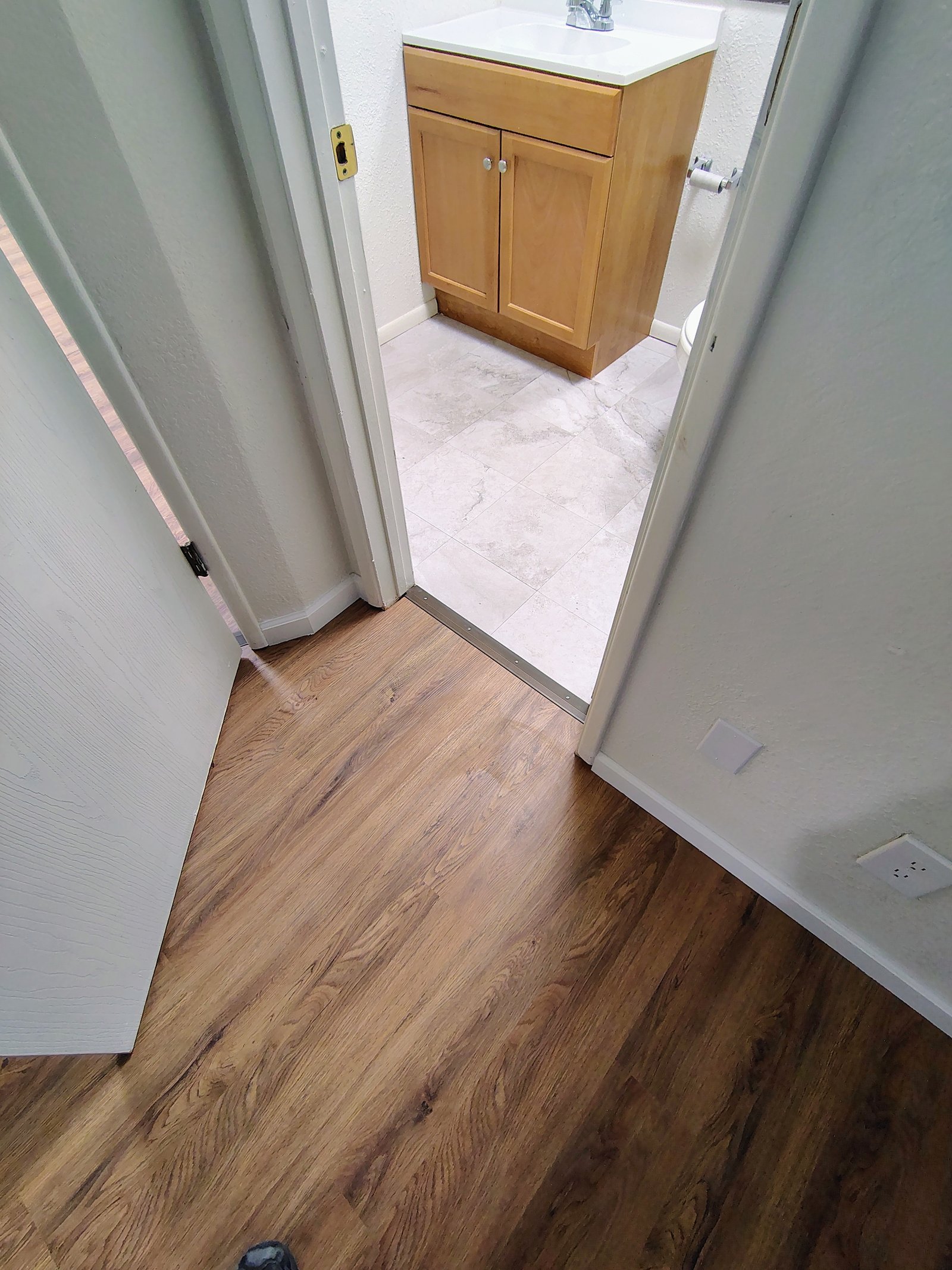 LVP and tile transition hallway to bathroom Tucson AZ